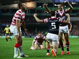 Shaun Kenny-Dowall of the Roosters celebrates with Anthony Minichiello after scoring his second try during the NRL World Club Challenge match between the Sydney Roosters and the Wigan Warriors at Allianz Stadium on February 22, 2014