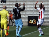 Ajaccio's Ivorian forward Junior Tallo is congratulated by a teammate after scoring a goal during the French L1 football match Ajaccio (ACA) against Lille (LOSC) on March 2, 2014