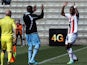 Ajaccio's Ivorian forward Junior Tallo is congratulated by a teammate after scoring a goal during the French L1 football match Ajaccio (ACA) against Lille (LOSC) on March 2, 2014