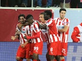 Olympiakos' Alejandro Dominguez is congratulated by teammates after scoring the opening goal against Manchester United during their Champions League match on February 25, 2014