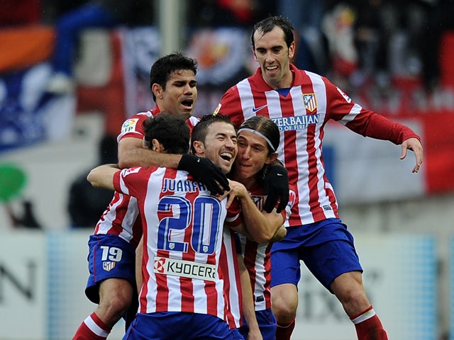 Atletico de Madrid players celebrate after scoring their 2nd goal during the La Liga match between Club Atletico de Madrid and Real Madrid CF at Vicente Calderon Stadium on March 2, 2014
