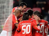 Benfica players celebrate their opening goal against PAOK during their Europa League match on February 27, 2014