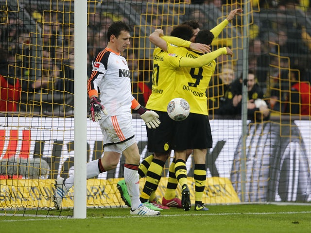 Dortmund's defender Mats Hummels celebrates scoring past Nuremberg's goalkeeper Raphael Schaefer with his teammates during the German first division Bundesliga football match Borussia Dortmund vs 1FC Nuernberg in Dortmund, western Germany, on March 1, 201