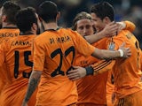 Real's Cristiano Ronaldo celebrates with teammates after scoring his team's third goal against Schalke during their Champions League match on February 26, 2014