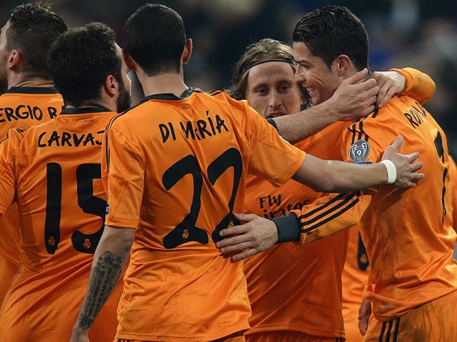 Real's Cristiano Ronaldo celebrates with teammates after scoring his team's third goal against Schalke during their Champions League match on February 26, 2014