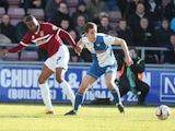 Emile Sinclair of Northampton Town looks for the ball with Tom Lockyer of Bristol Rovers during the Sky Bet League Two match on March 1, 2014