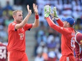 English bowler Stuart Broad celebrates with Jos Buttler after taking the wicket of West Indies batsman Darren Bravo during the second One Day International match bewteen West Indies and England at the Sir Vivian Richard Stadium in St John's, March 2, 2014