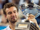 Latvia's Ernests Gulbis looks at his trophy after defeating France's Jo-Wilfried Tsonga during their Open 13 ATP tennis tournament final match on February 23, 2014