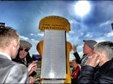 A bookmaker takes bets on the Grand National at Aintree racecourse on April 06, 2013
