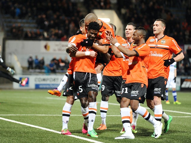 Lorient's Gabonese defender Bruno Ecuele Manga celebrates with teammates after scoring a goal during the French L1 football match between Lorient and Bastia on March 1, 2014