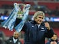 Manuel Pellegrini, manager of Manchester City celebrates victory with the trophy after the Capital One Cup Final between Manchester City and Sunderland at Wembley Stadium on March 2, 2014