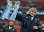 Manuel Pellegrini, manager of Manchester City celebrates victory with the trophy after the Capital One Cup Final against Sunderland on March 2, 2014
