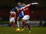 Massimo Luongo of Swindon Town is challenged by Michael Bostwick of Peterborough United during the Johnstone's Paint Southern Area Final Second Leg match between Swindon Town and Peterborough United at the County Ground on February 17, 2014