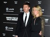 Manchester United's English midfielder Michael Carrick and his wife Lisa pose for photographs as they arrive for a gala dinner in aid of UNICEF at Old Trafford in Manchester on November 21, 2013