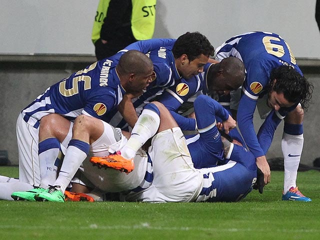 Porto's Nabil Ghilas is mobbed by teammates after scoring his team's third goal against Eintracht Frankfurt during their Europa League match on February 27, 2014