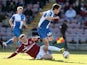 Tom Lockyer of Bristol Rovers attempts to move away from the challenge of Brennan Dickenson of Northampton Town during the Sky Bet League Two match between Bristol Rovers and Northampton Town at Sixfields Stadium on March 1, 2014