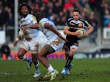 Exeter centre Phil Dollman (r) makes a break past Marland Yarde (l) and Topsy Ojo of London Irish during the Aviva Premiership match on March 1, 2014