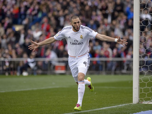 Real Madrid's French forward Karim Benzema celebrates after scoring during the Spanish league football match Club Atletico de Madrid vs Real Madrid CF at the Vicente Calderon stadium in Madrid on March 2, 2014