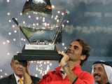 Roger Federer of Switzerland celebrates with his trophy after defeating Tomas Berdych of Czech Republic during their final match in the ATP Dubai Duty Free Tennis Championships on March 1, 2014