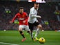 Ryan Tunnicliffe of Fulham competes with Juan Mata of Manchester United during the Barclays Premier League match between Manchester United and Fulham at Old Trafford on February 9, 2014