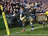 Joel Tomkins of Saracens is knocked into touch, just short of the try line by Bath standoff George Ford during the Aviva Premiership match between Bath and Saracens at the Recreation Ground on February 28, 2014