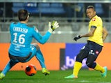 Sochaux French forward Jordan Ayew scores a goal past Bordeaux's French goalkeeper Cedric Carasso during the French L1 football match between FC Sochaux (FCSM) and Girondins de Bordeaux (FCGB) on March 1, 2014