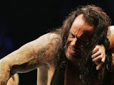The Undertaker (L) pushes Bam Neely into the corner during WWE Smackdown at Acer Arena on June 15, 2008