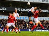 Michael Dawson of Tottenham Hotspur heads towards goal under pressure from Ben Turner of Cardiff City during the Barclays Premier League match between Tottenham Hotspur and Cardiff City at White Hart Lane on March 2, 2014