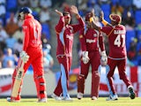 West Indies bowler Sunil Narine celebrates after taking the wicket of English batsman Joe Root during the first One Day International match bewteen West Indies and England at the Sir Vivian Richard Stadium in St John's on February 28, 2014