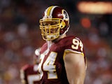Adam Carriker #94 of the Washington Redskins waits for play to resume against the Tampa Bay Buccaneers during the first half of a preseason game at FedExField on September 1, 2011