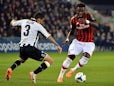 Udinese's Allan Marques Loureiro and AC Milan's Sulley Muntari in action during their Serie A match on March 8, 2014