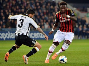 Udinese's Allan Marques Loureiro and AC Milan's Sulley Muntari in action during their Serie A match on March 8, 2014