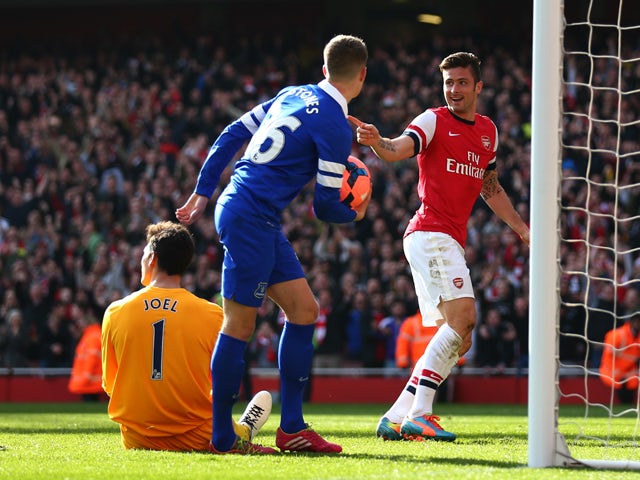 Olivier Giroud of Arsenal celebrates after scoring his team's third goal during the FA Cup Quarter-Final match between Arsenal and Everton at Emirates Stadium on March 8, 2014