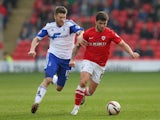 Dale Jennings of Barnsley holds off a challenge from Jamie Mackie of Nottingham Forest during the Sky Bet Championship match between Barnsley and Nottingham Forest at Oakwell on March 08, 2014