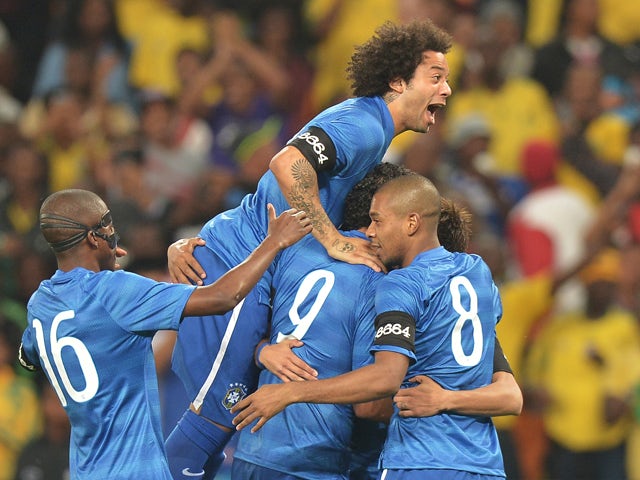 Brazil's players celebrates after scoring a goal during a friendly football match between South Africa and Brazil at Soccer City stadium in Soweto, outside Johannesburg, on March 5, 2014