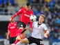 Cardiff City player Gary Medel challenges Cauley Woodrow of Fulham during the Barclays Premier league match between Cardiff City and Fulham at Cardiff City Stadium on March 8, 2014 