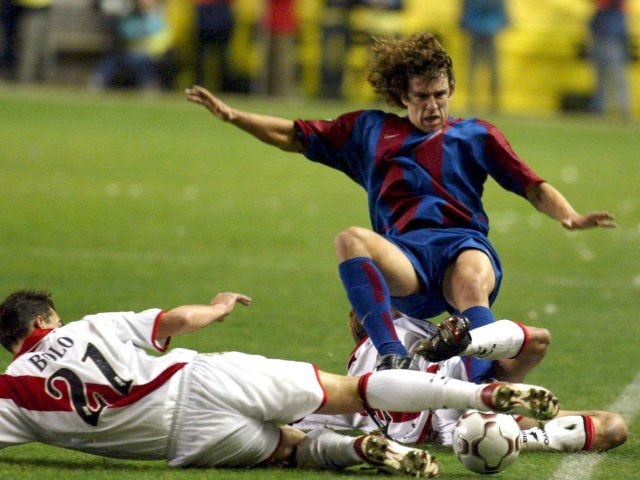 Barcelona's Carles Puyol performs a slide tackle against Rayo Vallecano on December 07, 2002.