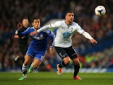 Kyle Walker of Spurs holds off the challenge from Eden Hazard of Chelsea during the Barclays Premier League match between Chelsea and Tottenham Hotspur at Stamford Bridge on March 8, 2014