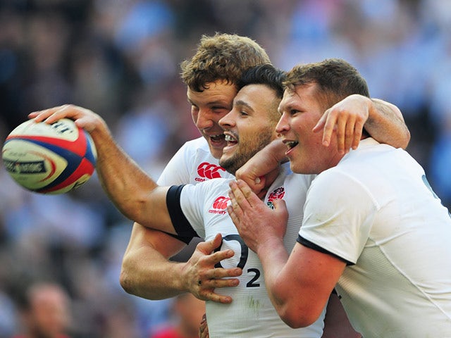 England's Canny Care celebrates with teammates after scoring the first try against Wales during their Six Nations international match on March 9, 2014