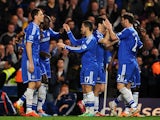 Chelsea's Demba Ba celebrates with teammates after scoring his team's fourth goal against Tottenham during their Premier League match on March 8, 2014