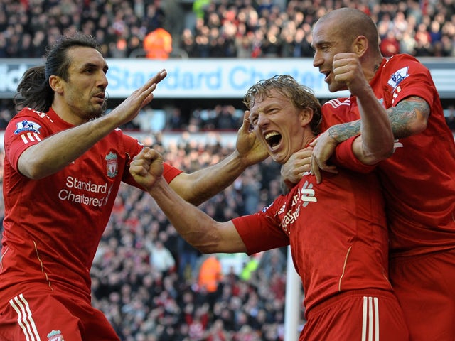 Liverpool's Dutch forward Dirk Kuyt celebrates with Liverpool's Portuguese midfielder Raul Meireles and Liverpool's Greek defender Sotirios Kyrgiakos after scoring his third goal during the English Premier League football match between Liverpool and Manch