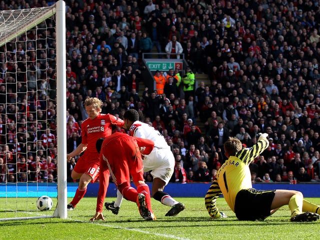 Dirk Kuyt of Liverpool scores the opening goal during the Barclays Premier League match between Liverpool and Manchester United at Anfield on March 6, 2011