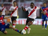 River Plate's defender Eder Alvarez Balanta vies for the ball with Tigre's midfielder Joaquin Arzura during their Argentine First Division football match, at the Monumental stadium in Buenos Aires, Argentina, on September 8, 2013