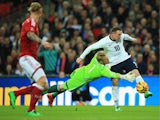 Wayne Rooney of England goes round Kasper Schmeichel of Denmark during the International Friendly match between England and Denmark at Wembley Stadium on March 5, 2014