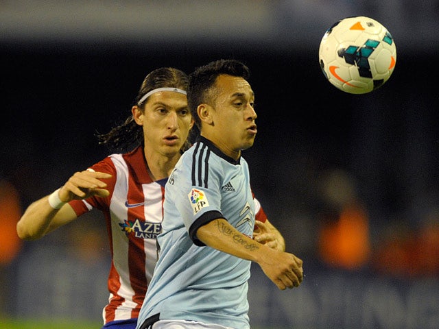 Celta's Fabian Orellana and Atletico Madrid's Filipe Luis in action during their La Liga match on March 8, 2014