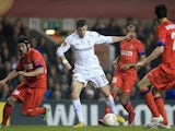 Gareth Bale of Tottenham Hotspur runs with the ball as Cristian Chivu of FC Internazionale Milano (L) closes him down during the UEFA Europa League match on March 7, 2013