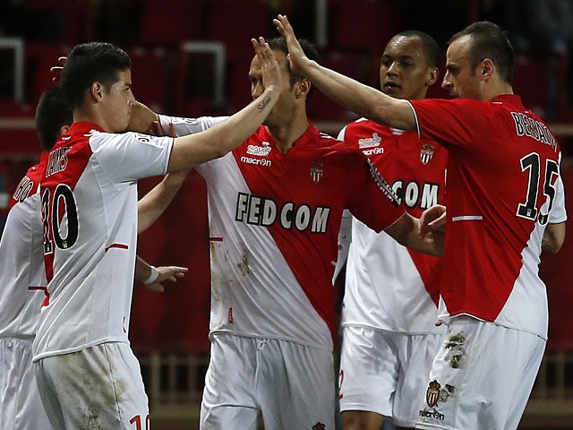 Monaco's James Rodriguez celebrates with teammates after scoring his team's second goal against Sochaux during their Ligue 1 match on March 8, 2014
