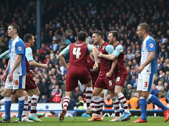 Burnley's Jason Shackell celebrates with teammates after scoring his team's first goal against Blackburn during their Championship match on March 9, 2014