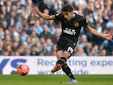 Wigan's Jordi Gomez scores the opening goal via the penalty spot against Manchester City during their FA Cup quarter-final match on March 9, 2014