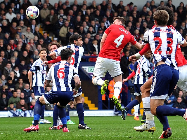 Manchester United's English defender Phil Jones heads the ball to score his team's first goal during the English Premier League football match between West Bromwich Albion and Manchester United at The Hawthorns in West Bromwich, central England, on March 